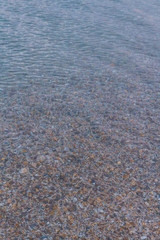 Sea stones in the summer sea before sunset