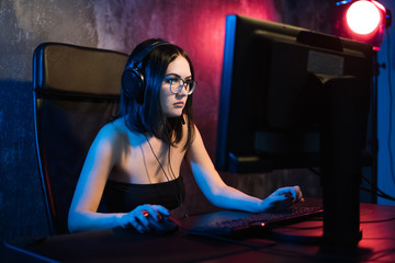 Professional Girl Gamer Plays in MMORPG or Strategy Video Game on Her Computer. She's Participating...