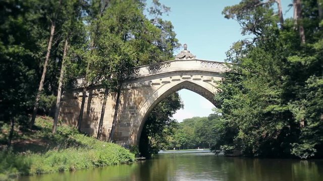 Old Stone Bridge At Laxenburg Castle In Austria Shot From The Moving Boat