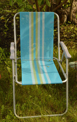 camping chair is set in the garden on the grass