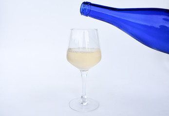 Glass with wine and bottle