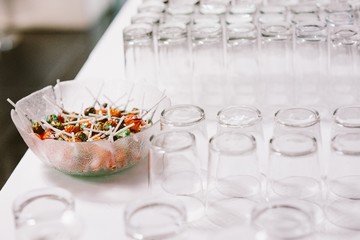 Many glass glasses ready to serve drinks at a party.