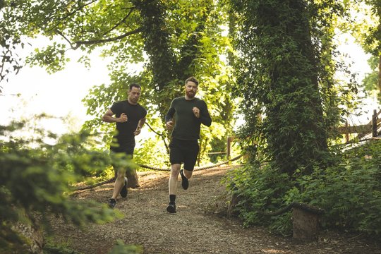 Two mens jogging together at boot camp