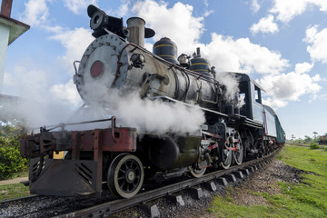Fototapeta premium Stara lokomotywa parowa lub pociąg kolejowy przybywający na peron