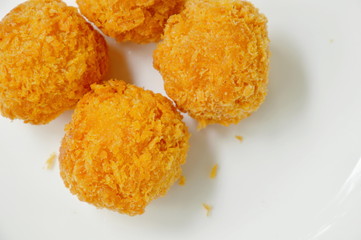 crispy fried cheese ball on white plate
