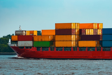 Red container ship underway