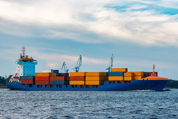 Blue container ship underway