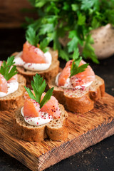 Rye bread, salmon and soft cheese. Sandwich with red fish. Selective focus.