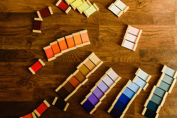 Fototapeta na wymiar Montessori color tablets on wooden floor background