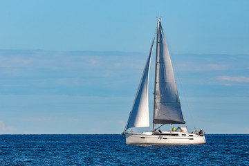 White sailboat traveling at Riga