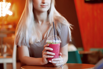 Beautiful Young Woman with Fruit smoothie