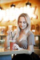Beautiful Young Woman with Fruit smoothie