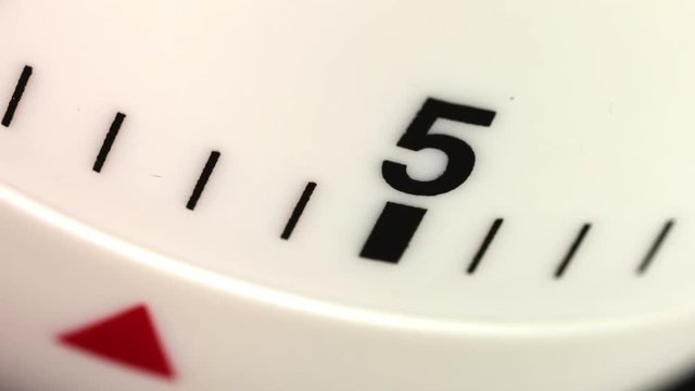 White kitchen egg timer countdown to zero time lapse.
