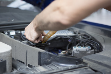 People are repair a car Use a wrench and a screwdriver to work.Safe and confident in driving