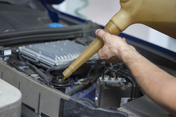 People are repair a car Use a wrench and a screwdriver to work.Safe and confident in driving