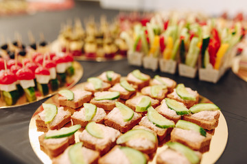 Tiny catering snacks on table. Horizontal photo.