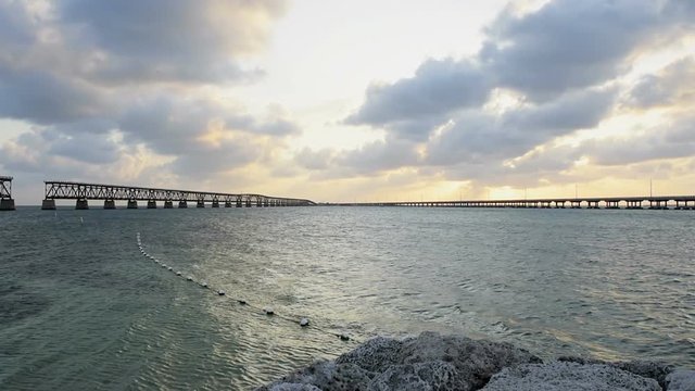Sunset dark evening clouds in Bahia Honda State Park, Florida Keys, with old railroad bridges, ocean and gulf of mexico, slow motion
