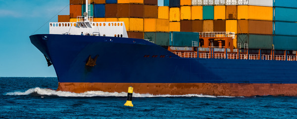 Blue container ship underway