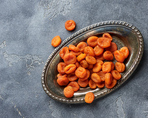 Dried apricots on gray background. witn copy space. Top view.