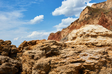 beautiful sea landscape, closeup of stone on the beach, sea coast with high hills, wild nature