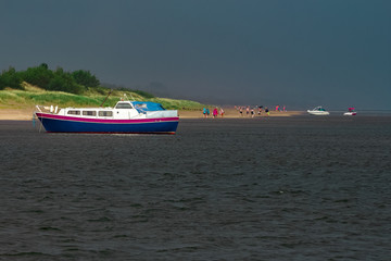 Obraz premium Small blue passenger ship