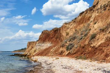 Fototapeta na wymiar beautiful sea landscape, closeup of stone on the beach, sea coast with high hills, wild nature