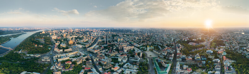 A big 360 degrees panorama of the city of Kiev at sunset. A modern metropolis in the center of Europe against the backdrop of sunset sky from a bird's eye view. Aerial view. Panorama of the Tourist
