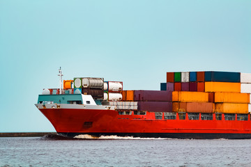 Red container ship underway