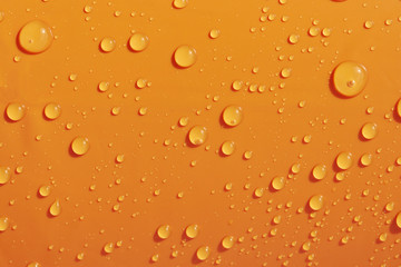 Fototapeta na wymiar Water drops on orange