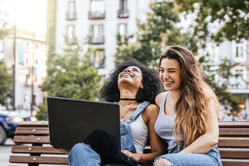 Beautiful women using a laptop in the Street.