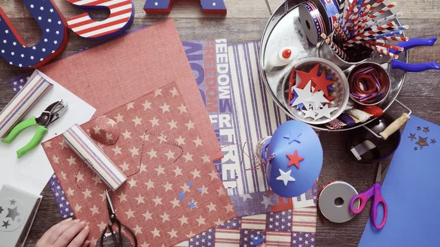Step by step. Mother and daughter making paper firecrackers for July 4th celebration