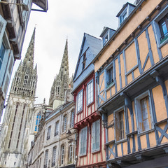 Fototapeta na wymiar Quimper in Brittany, the Saint-Corentin cathedral, view from a medieval street 