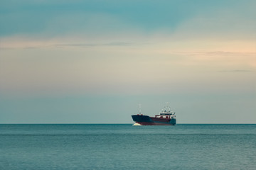 Blue cargo ship underway