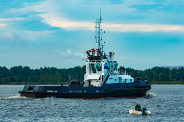 Black tug ship underway
