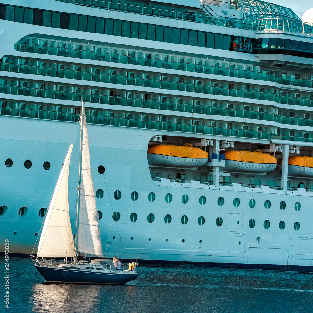 Canvas Prints Blue sailboat against cruise liner