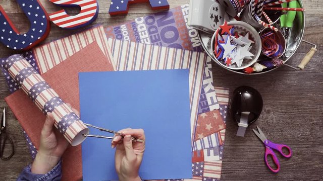 Step by step. Mother and daughter making paper firecrackers for July 4th celebration