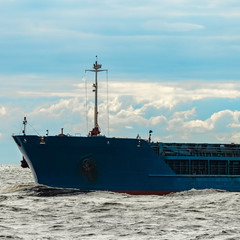 Blue cargo ship underway