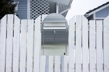 A silver outdoor mailbox at winter in Finland.