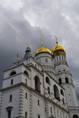 Fototapeta na wymiar Inside the Moscow Kremlin. The bell tower of Ivan the Great against the background of thunderclouds.