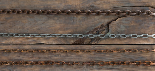 Wood board with iron chain link.Old rusty chains