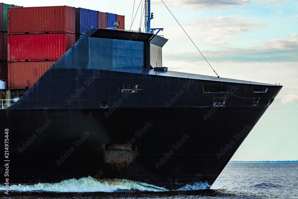 Wall mural Black container ship underway