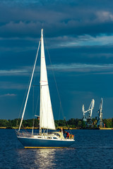 Blue sailboat at river