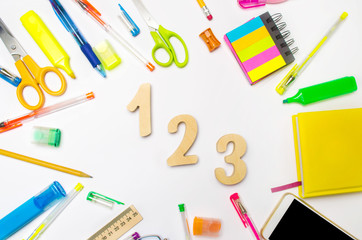 mathematics. numbers 1, 2, 3 on the school desk. concept of education. back to school. stationery. White background. stickers, colored pens, pencils, scissors. view from above. flat lay.
