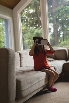 Girl using virtual reality headset in living room
