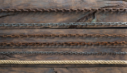 Wood board with iron chain link.Old rusty chains