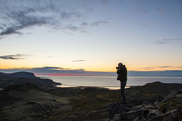 Fototapeta premium Photographer watching the sun set