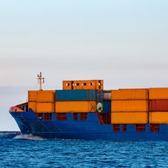 Blue container ship underway