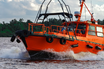 Orange pilot boat in action
