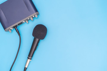 Black microphone on blue background for music concept