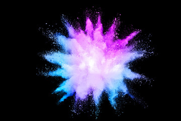 Freeze motion of color powder exploding on black background.